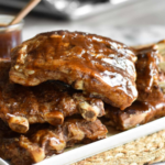 Slow cooker ribs stacked on top of each other.