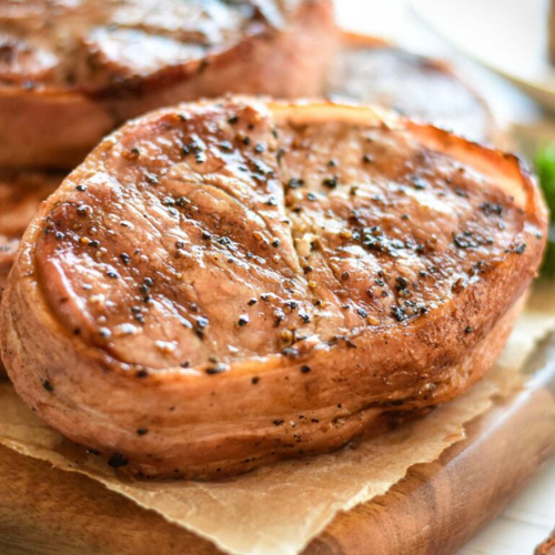 Pork tenderloin medallions with bacon wrapped around them