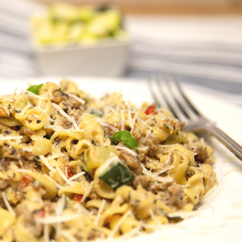 Italian Sausage and Peppers Pasta served up on a white plate.