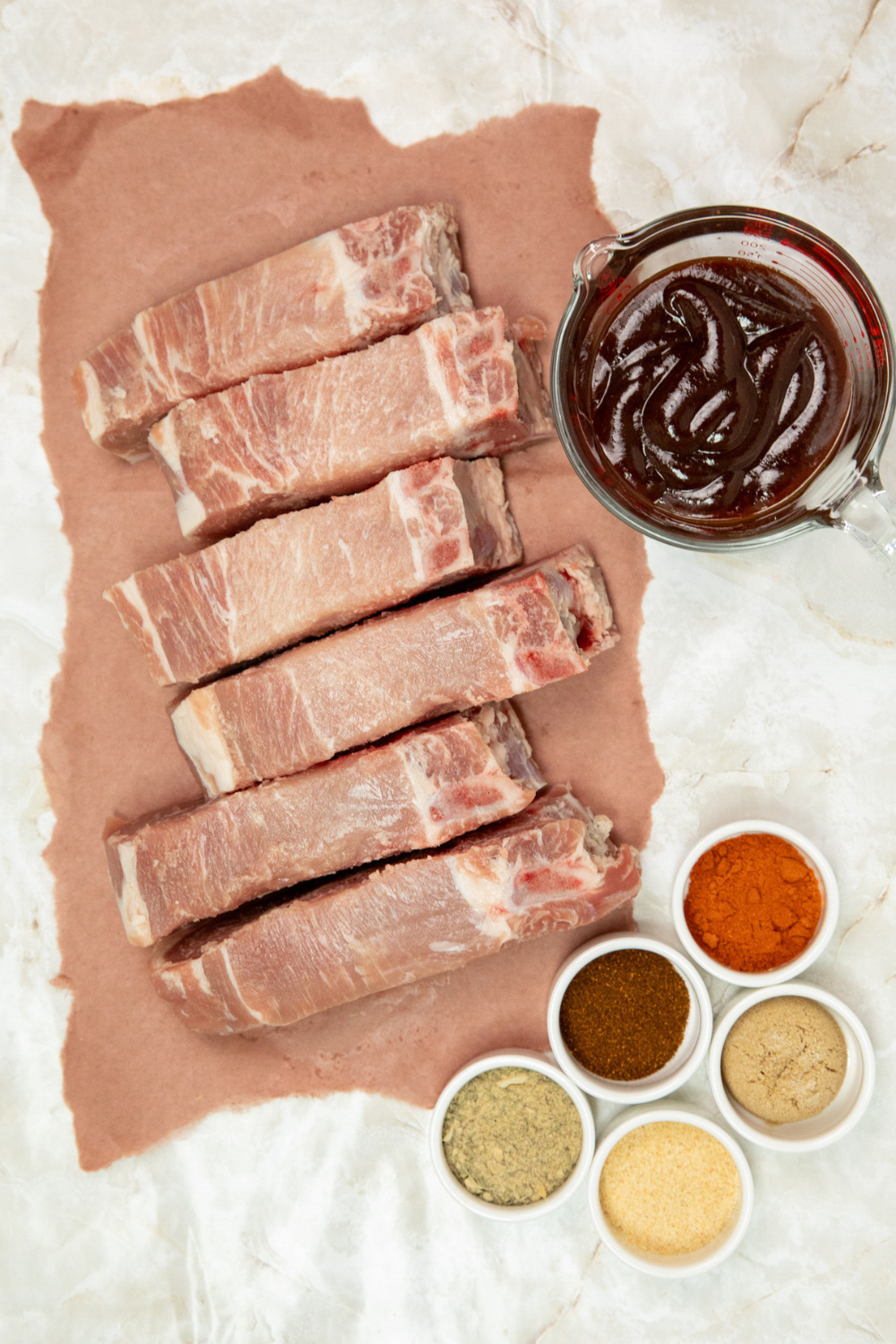 Ingredients for air fryer country style ribs measured out into white dishes.