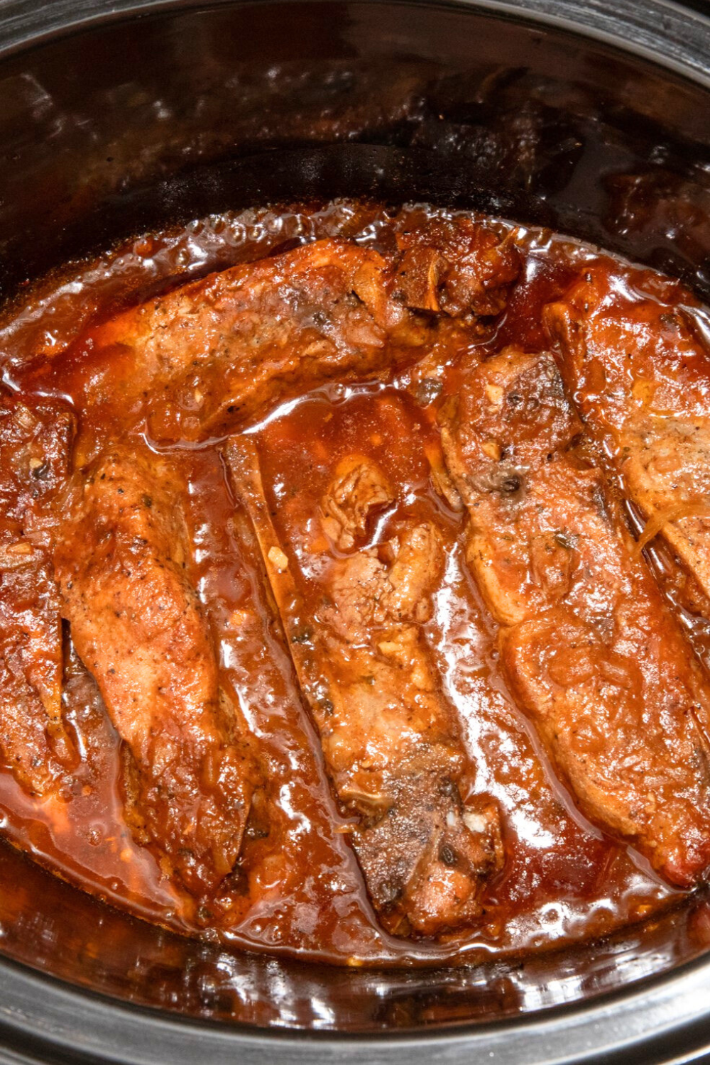 fully-cooked-crock-pot-ribs Cooked country style ribs in crock pot and bbq sauce.
