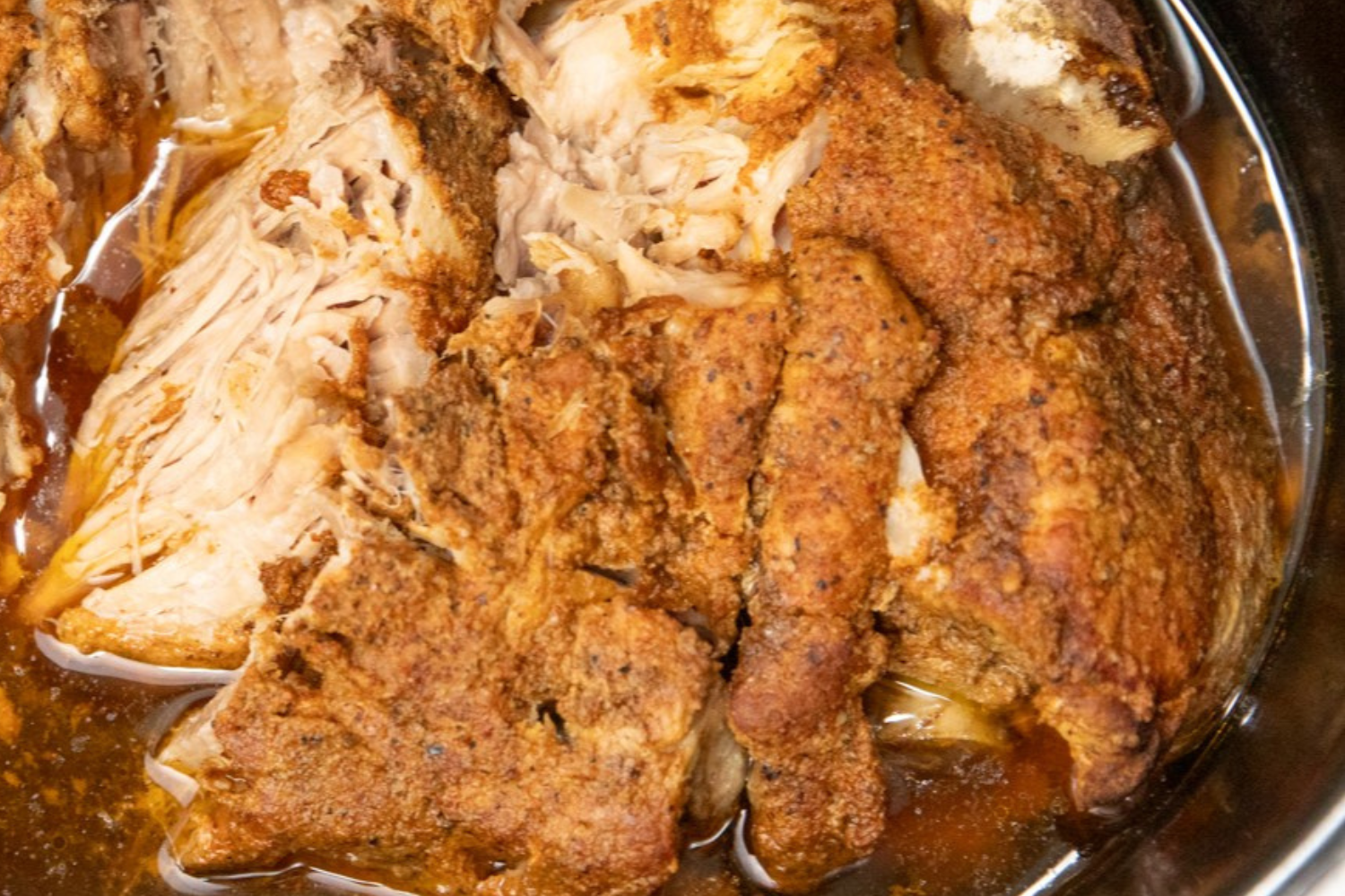 Photo of slow cooked pork shoulder in crock pot.