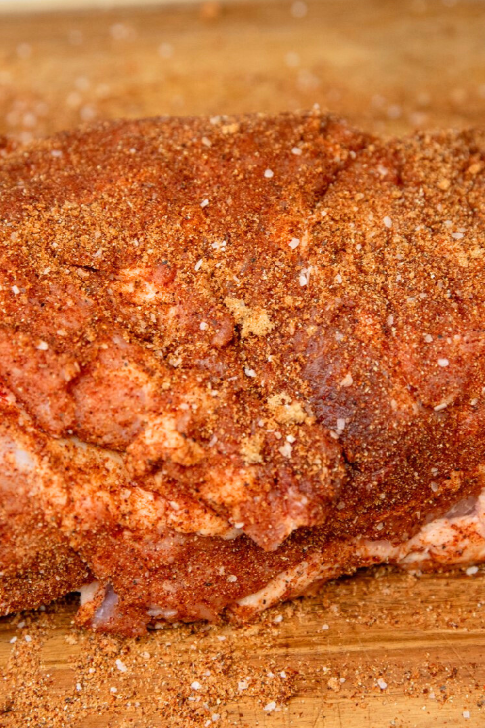Spice rub mixture covering pork shoulder butt roast.