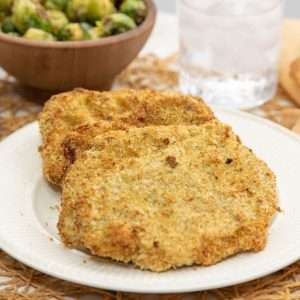 Breaded pork cutlets with a side of vegetables.