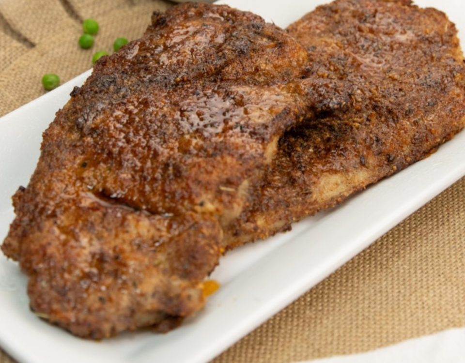 Air Fryer Pork Steaks on a white plate.