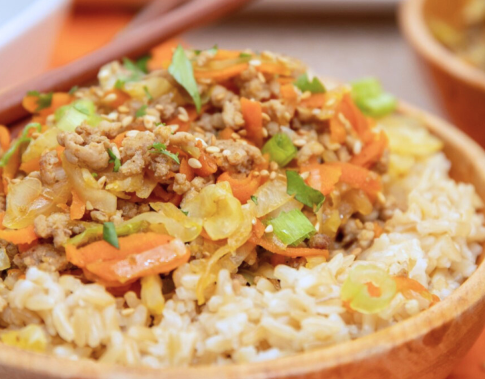 Ground pork egg roll in a bowl with rice.