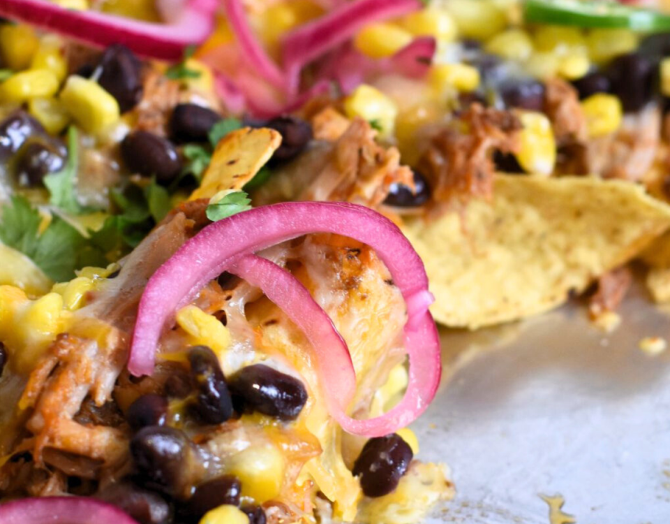 Sheet pan with pulled pork nachos.