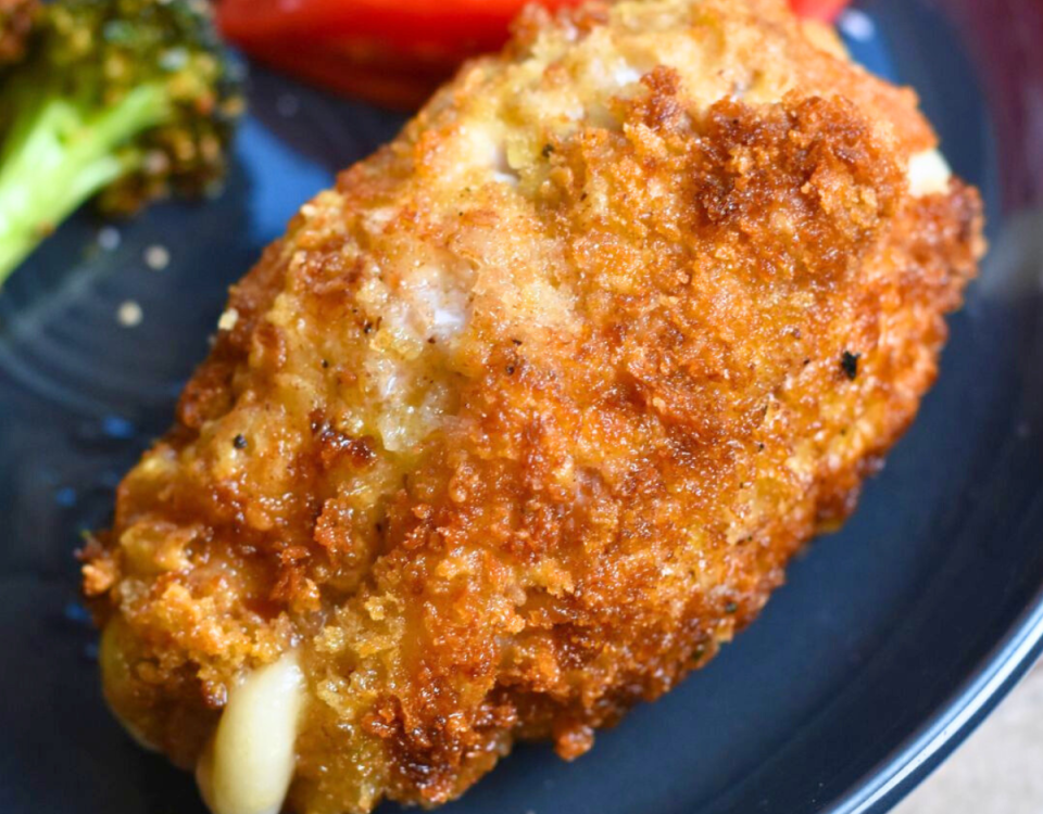 Melty cheese coming out of breaded pork cordon bleu.