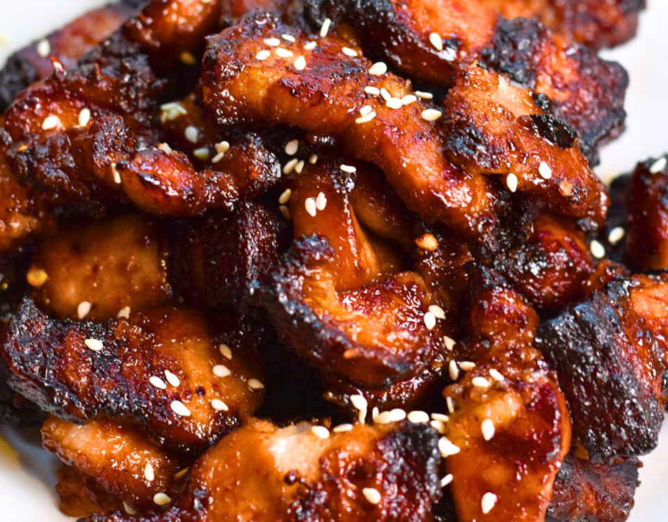 Air fryer pork belly bites on a plate.