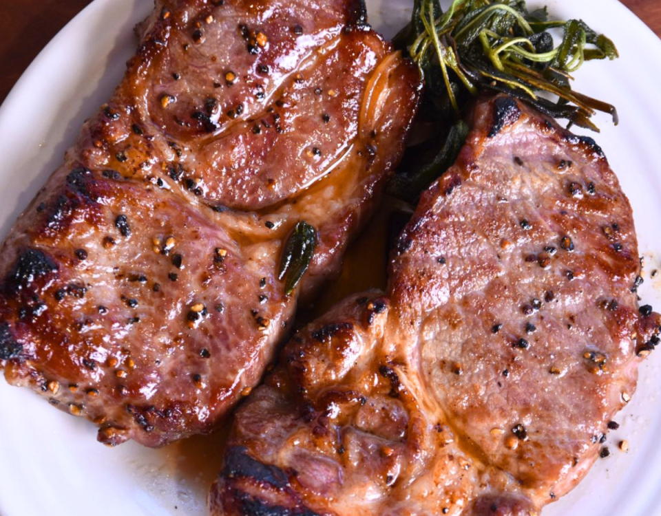 Coppa pork steak on white plate.